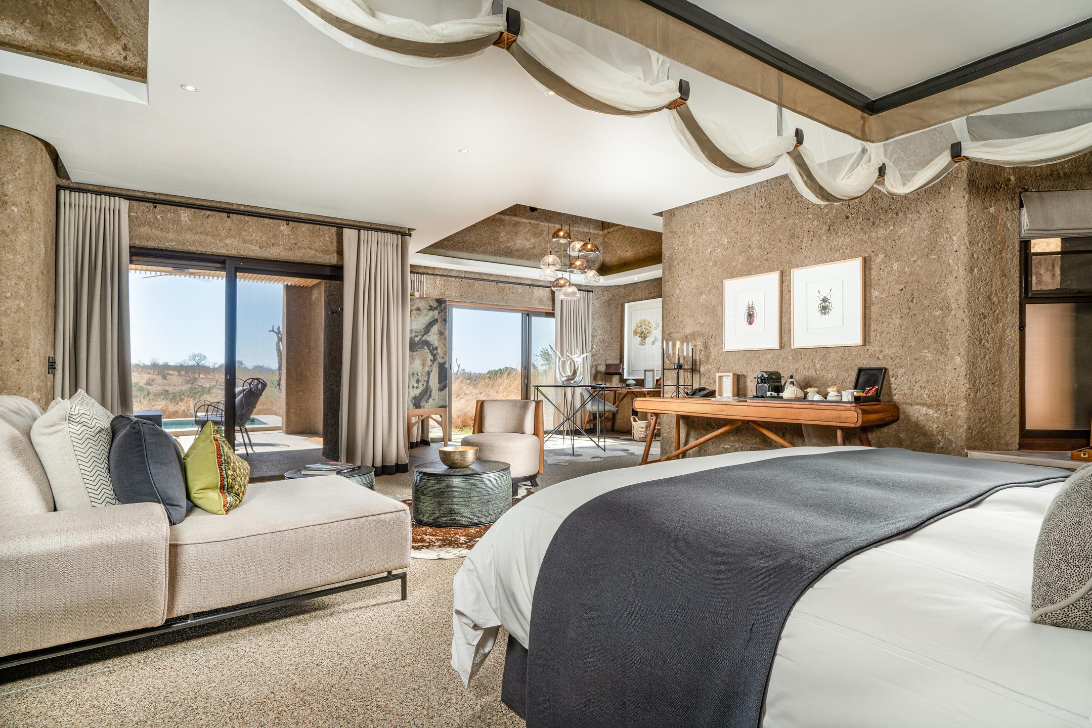 <p>Each bedroom is fitted with a king-size bed, draped with soft linens and plush pillows, ensuring a good night's sleep. The beds are positioned to face the large sliding glass doors that open onto a private deck, providing guests with stunning views of the surrounding bushveld.</p>